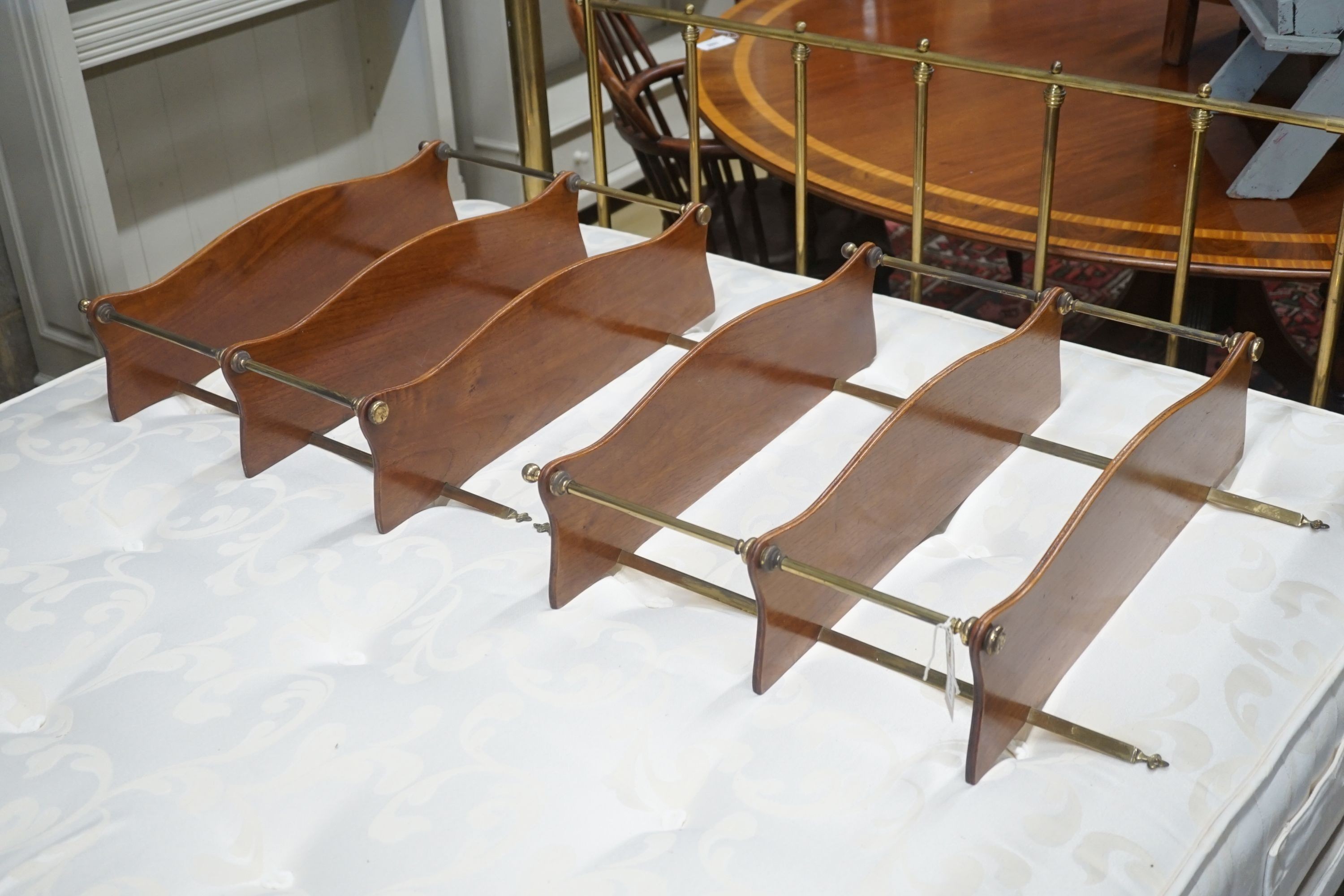 A pair of brass mounted serpentine mahogany three tier wall brackets, width 60cm depth 17cm height 70cm